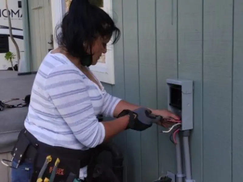 Licensed electrician wiring an exterior subpanel in Granby